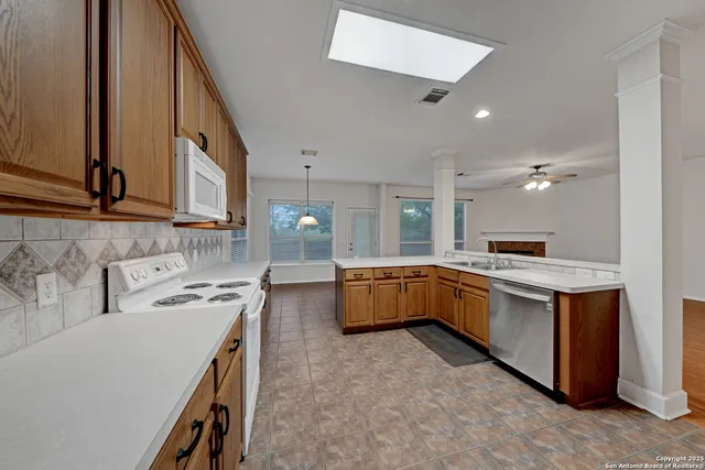 a kitchen that has a sink and a stove in it