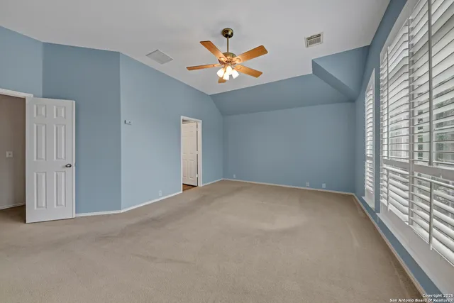 a room with a large window and wooden floor