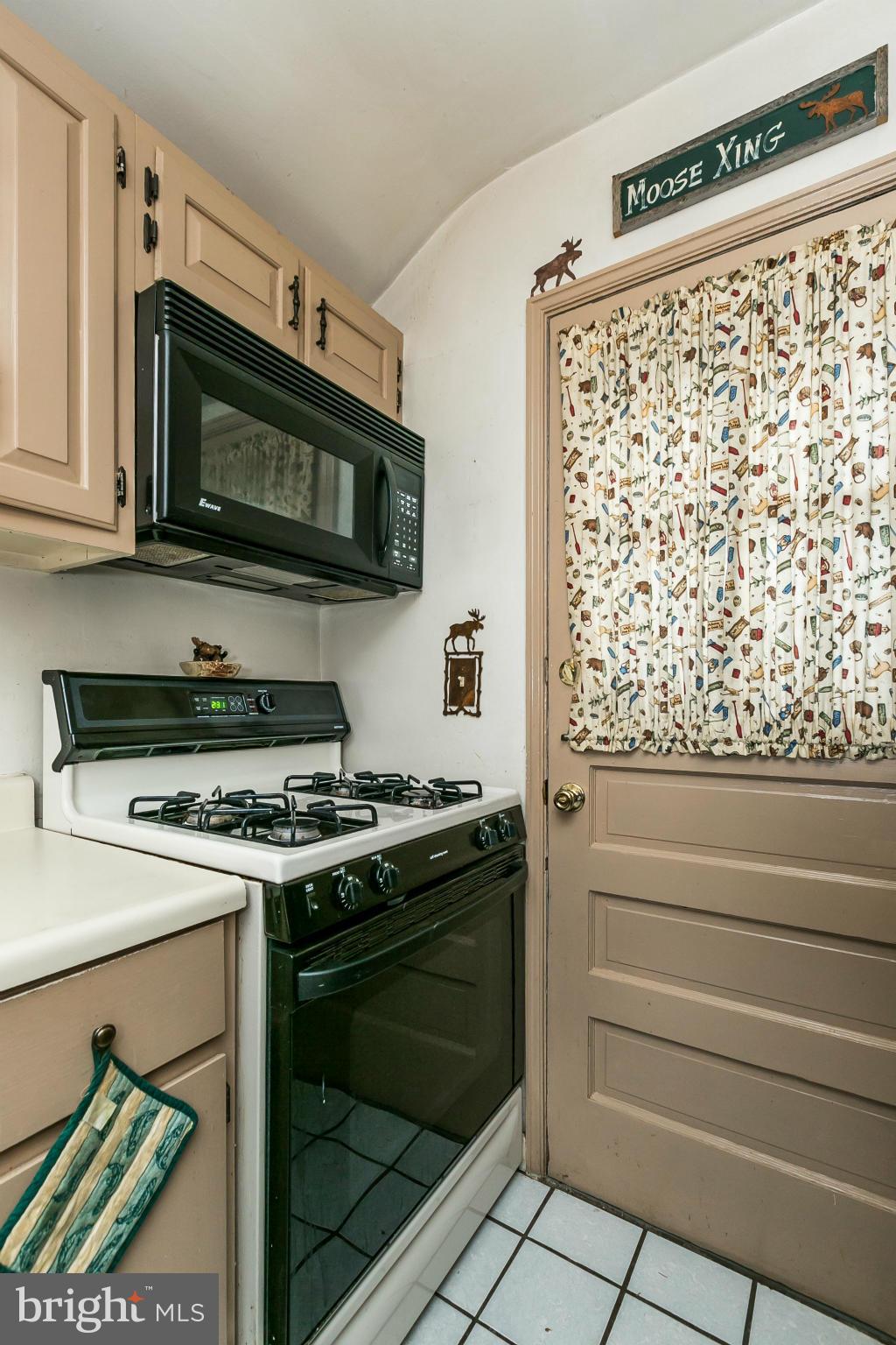 2907 Weisman Road Silver Spring, MD 20902 - Photo 11 of 30 a kitchen with stainless steel appliances granite countertop a stove and a microwave
