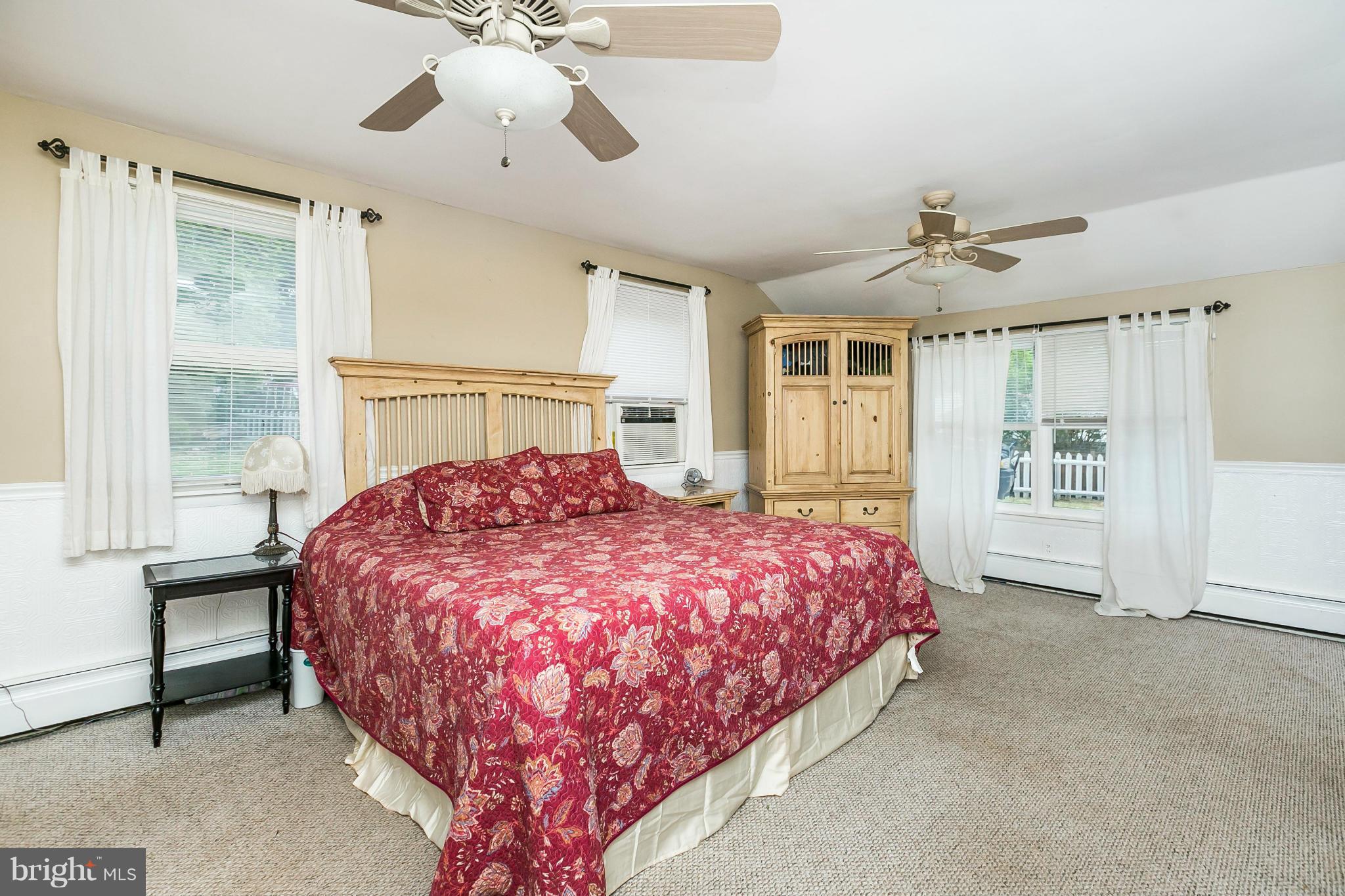 2907 Weisman Road Silver Spring, MD 20902 - Photo 13 of 30 a spacious bedroom with a bed and a chandelier