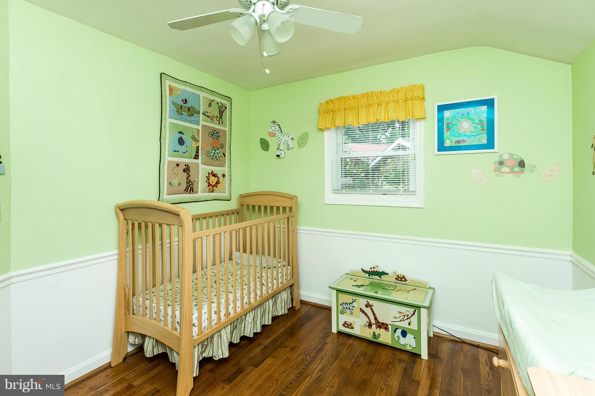 2907 Weisman Road Silver Spring, MD 20902 - Photo 21 of 30 a bedroom with a bed and wooden floor
