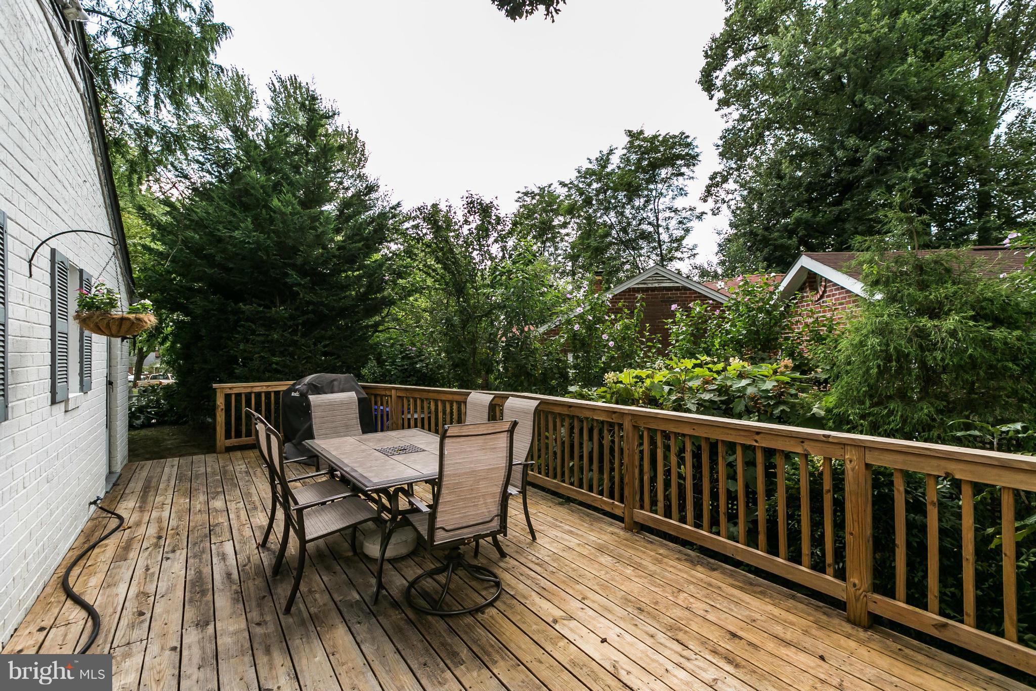 2907 Weisman Road Silver Spring, MD 20902 - Photo 26 of 30 a view of a deck with furniture and trees