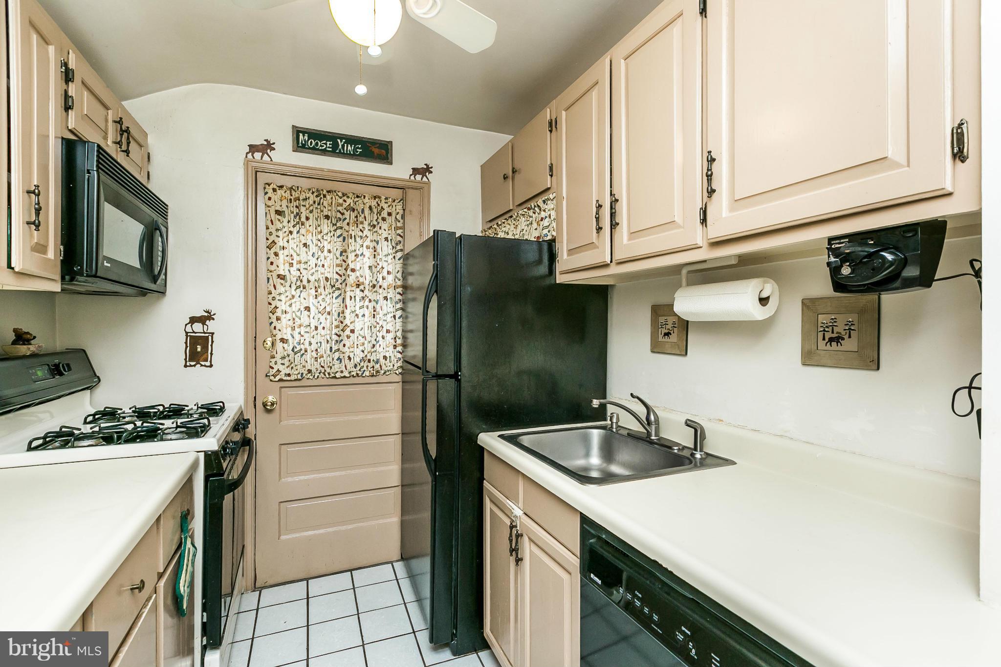 2907 Weisman Road Silver Spring, MD 20902 - Photo 8 of 30 a kitchen with stainless steel appliances granite countertop a sink a stove and a refrigerator