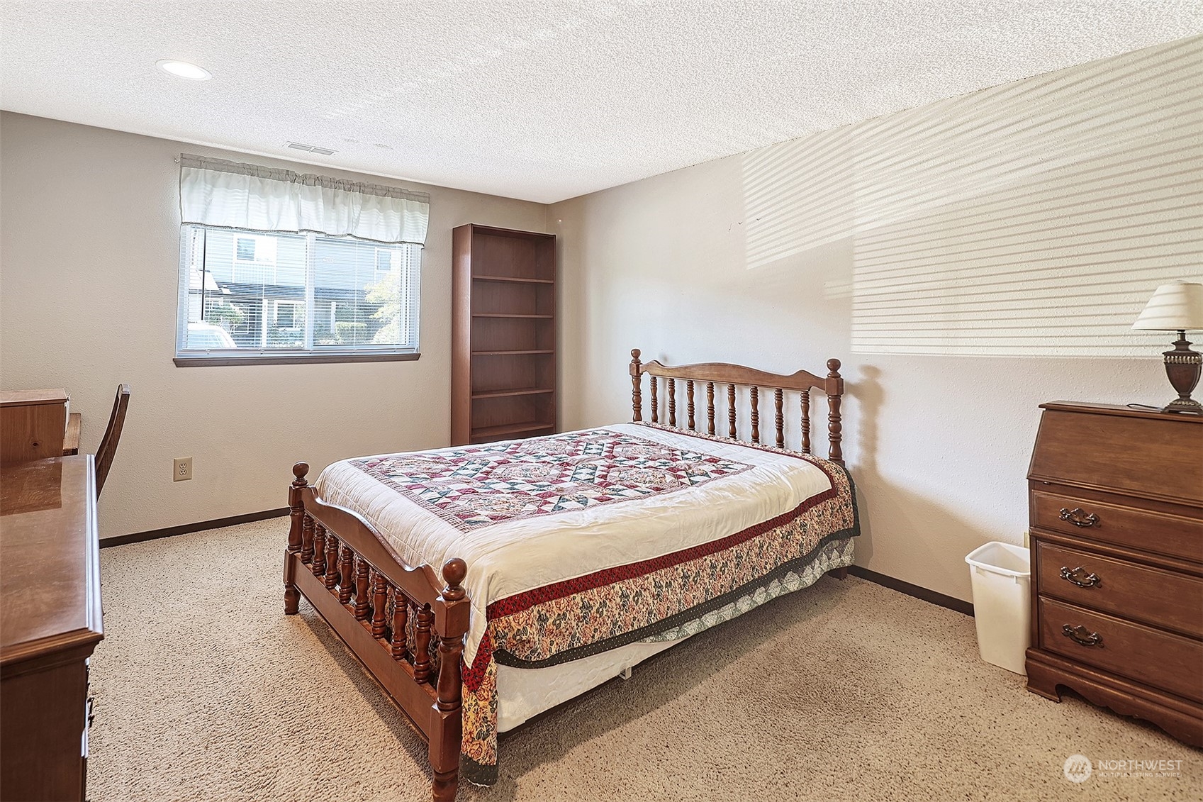 21509 4th Avenue West, Unit A21 Bothell, WA 98021 - Photo 11 of 17 a bed sitting in a bedroom next to a window