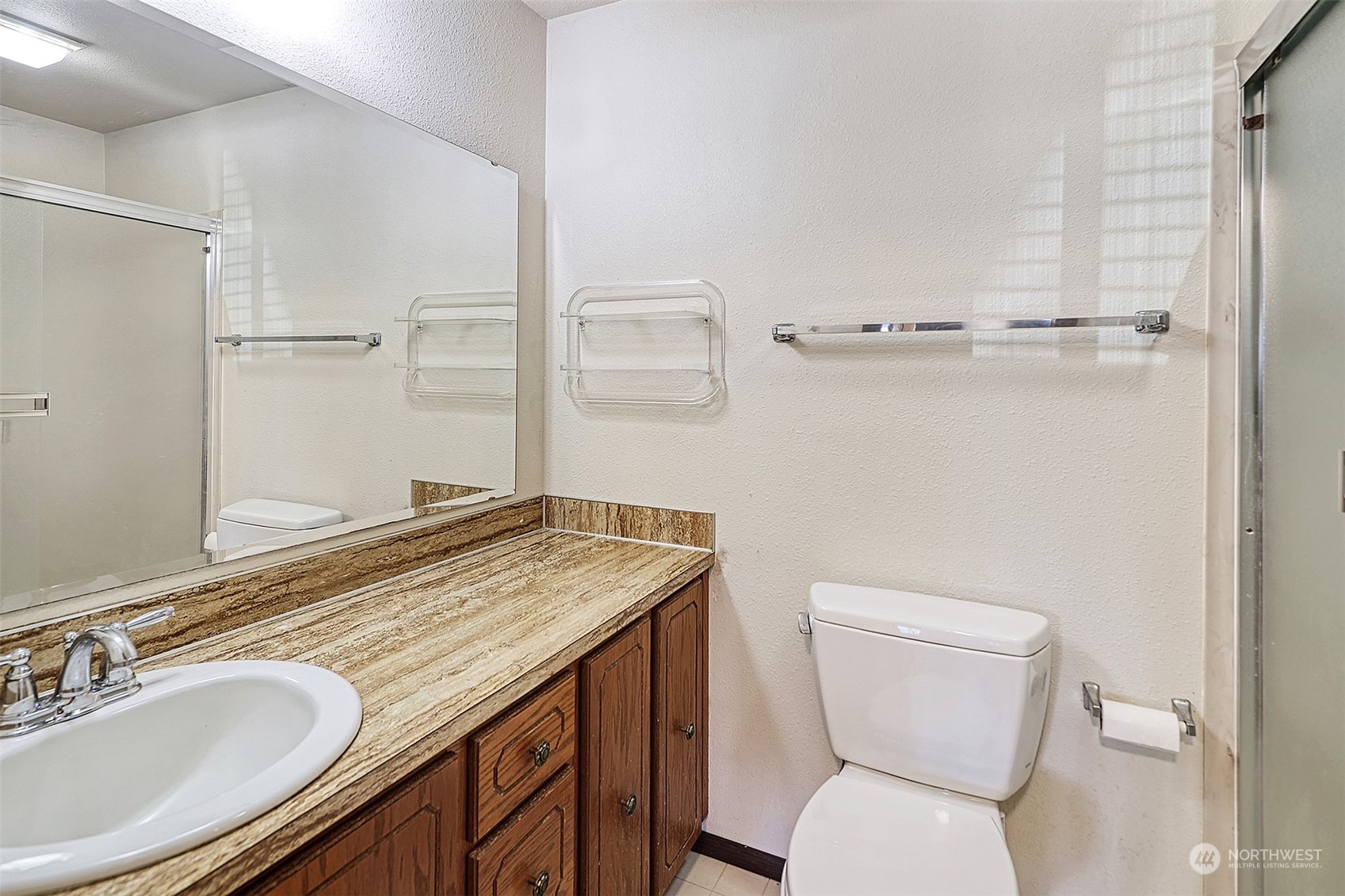21509 4th Avenue West, Unit A21 Bothell, WA 98021 - Photo 12 of 17 a bathroom with a granite countertop toilet sink and mirror