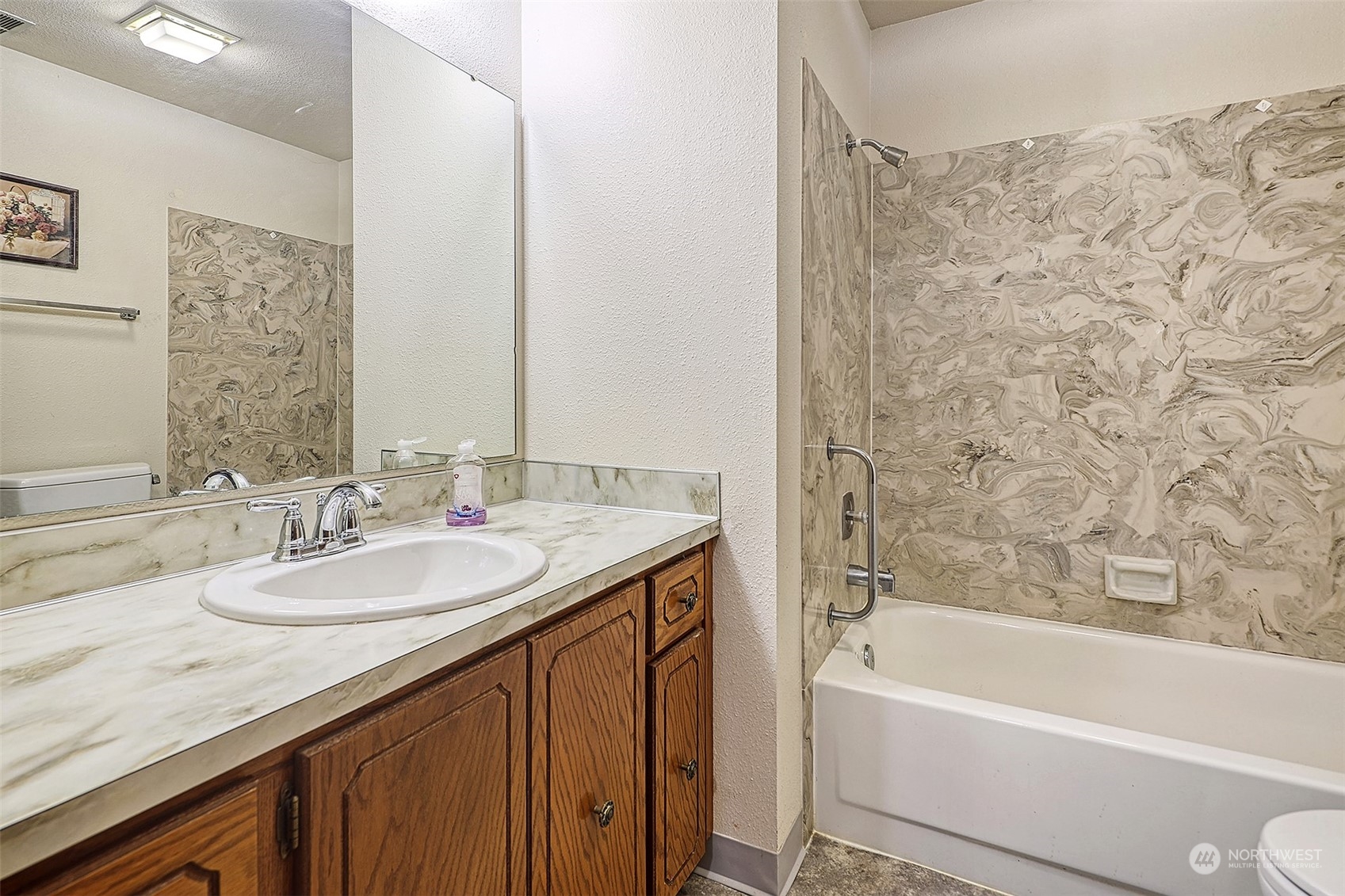 21509 4th Avenue West, Unit A21 Bothell, WA 98021 - Photo 14 of 17 a bathroom with a granite countertop sink and a bathtub