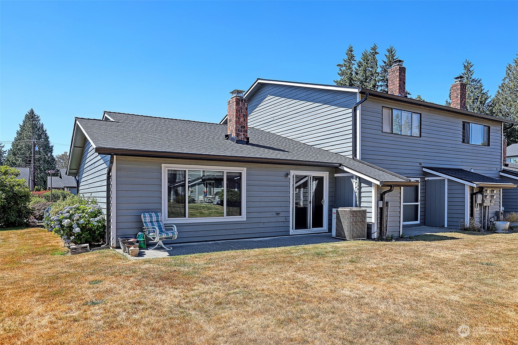 21509 4th Avenue West, Unit A21 Bothell, WA 98021 - Photo 17 of 17 a front view of a house with a yard and garage