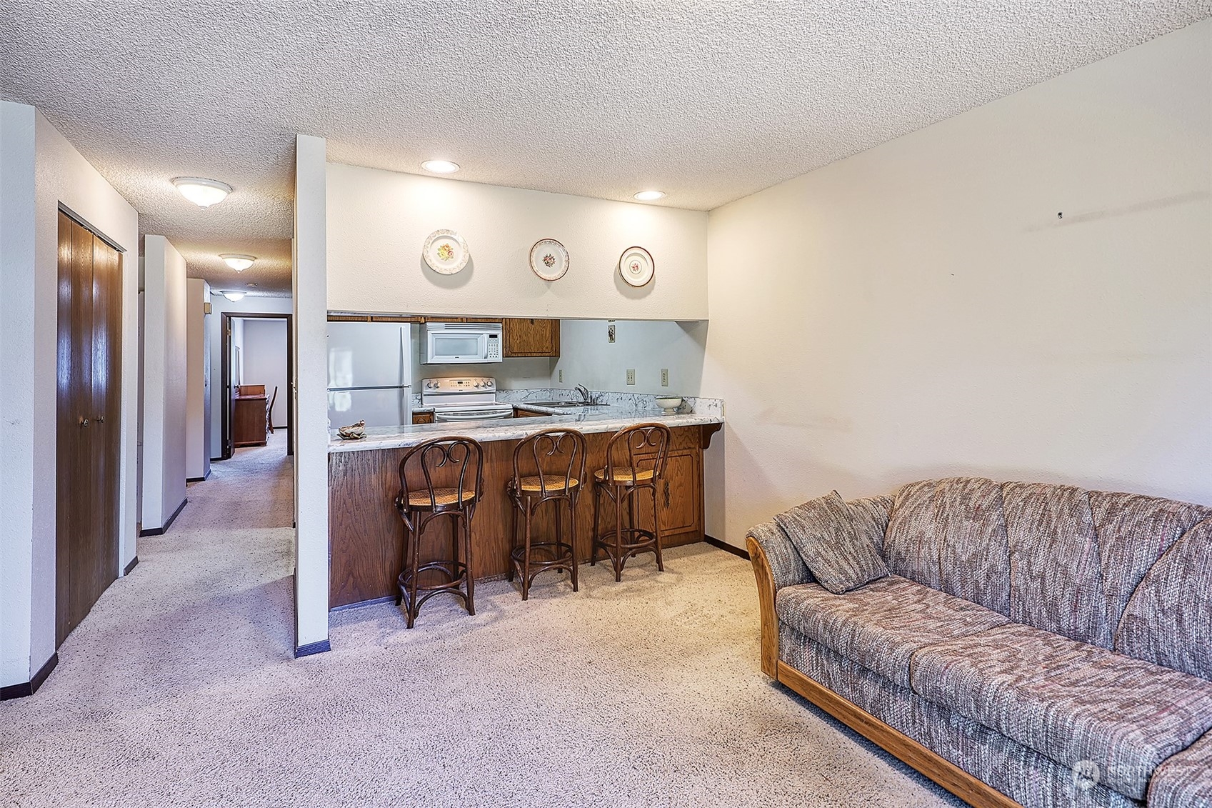 21509 4th Avenue West, Unit A21 Bothell, WA 98021 - Photo 7 of 17 a living room with furniture and kitchen
