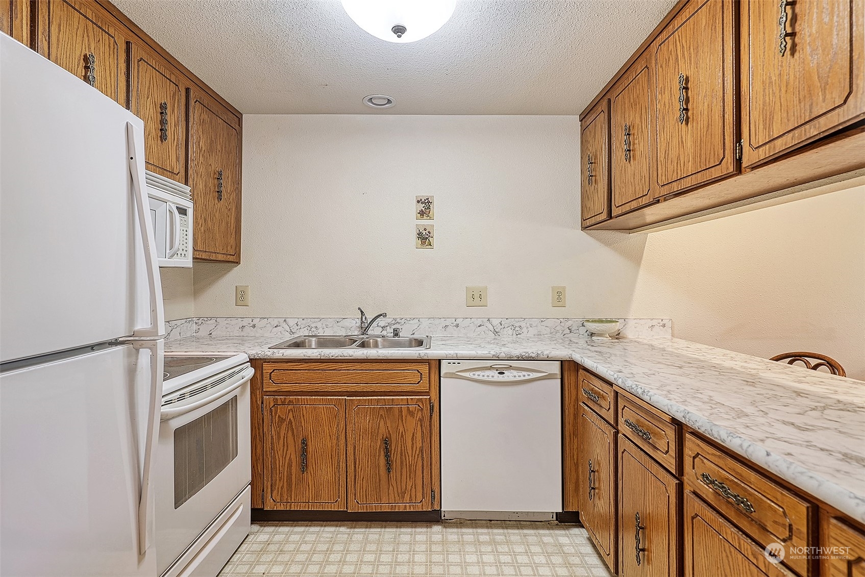 21509 4th Avenue West, Unit A21 Bothell, WA 98021 - Photo 9 of 17 a kitchen with a sink stove and cabinets