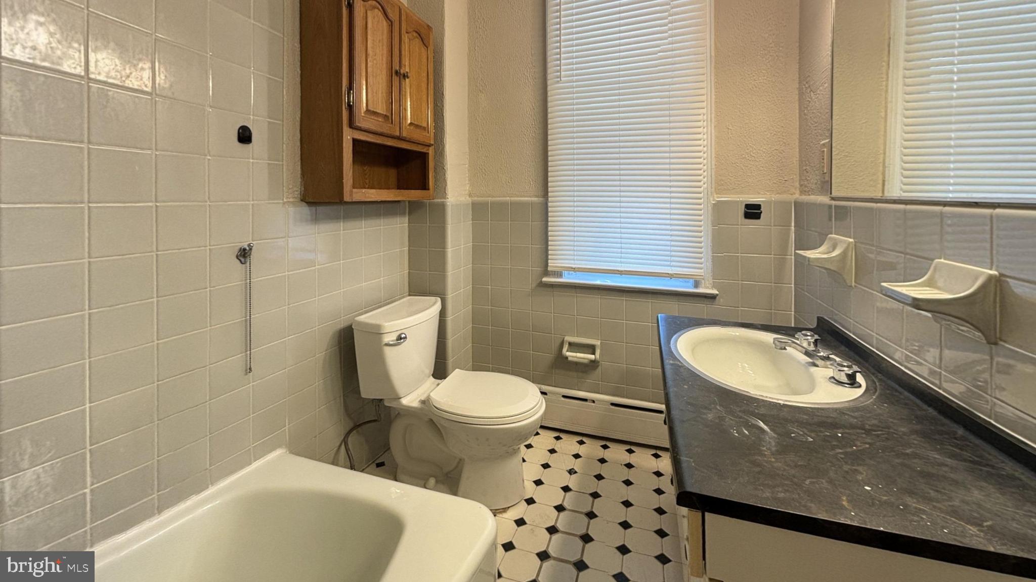 644 Littlecroft Road Upper Darby, PA 19082 - Photo 6 of 7 a bathroom with a sink toilet and shower