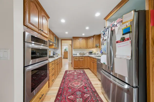 a kitchen with granite countertop stainless steel appliances and refrigerator