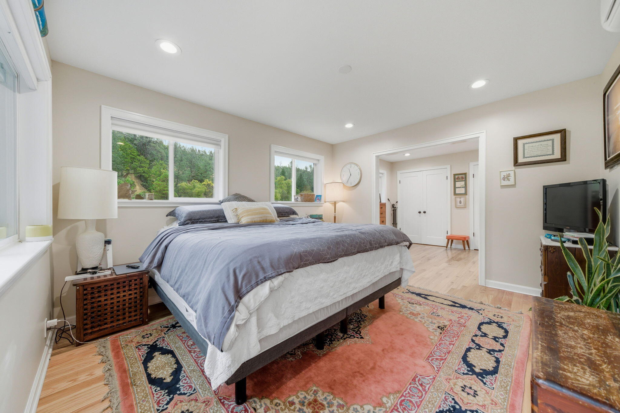 7848 Rush Creek Road Lewiston, CA 96052 - Photo 18 of 44 a spacious bedroom with a bed and a flat screen tv