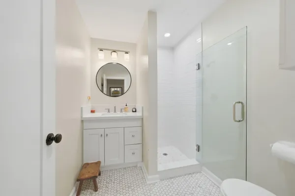 a bathroom with a sink a toilet and shower