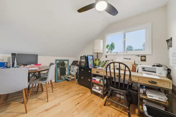 a living room with furniture a flat screen tv and a window