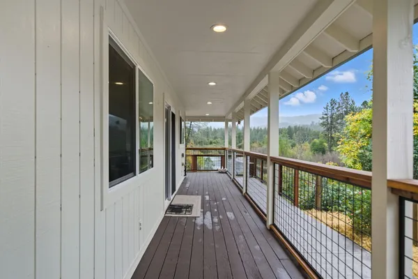 a view of a balcony with wooden floor