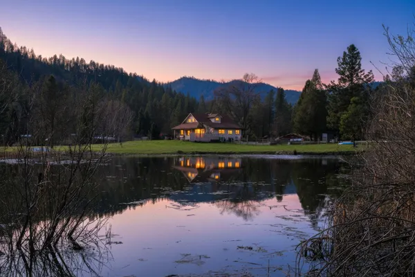 a view of a lake in between two of trees