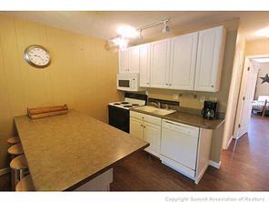 1513 East Keystone Road, Unit 2964 Keystone, CO 80435 - Photo 4 of 17 a kitchen with stainless steel appliances cabinets and wooden floor