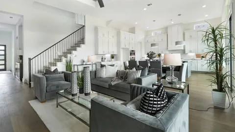 a living room with furniture kitchen view and a potted plant