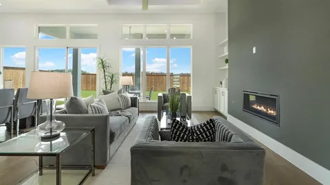 a living room with furniture fireplace and a large window