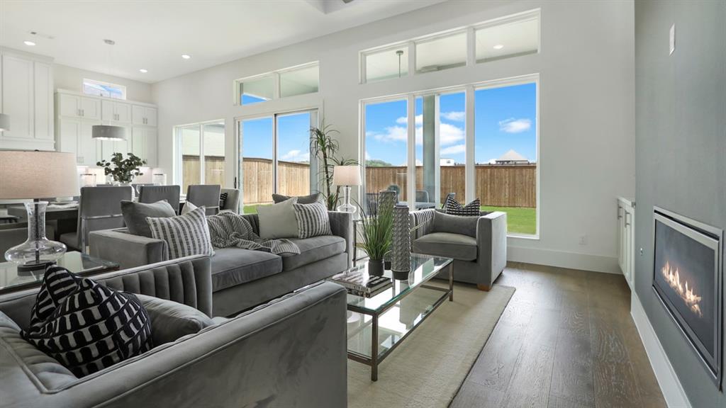 165 Lantern Ridge Drive Aledo, TX 76008 - Photo 28 of 38 a living room with furniture floor to ceiling window and a flat screen tv