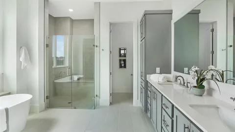 a bathroom with a double vanity sink mirror and shower