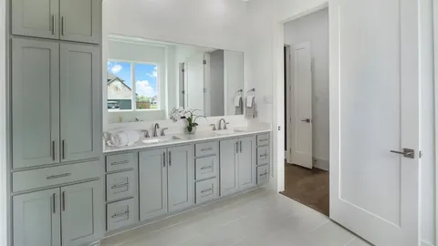 a spacious bathroom with a double vanity sink mirror and double