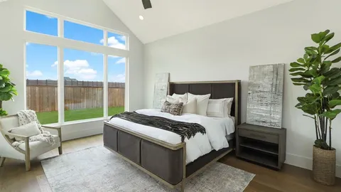 a bed sitting in a bedroom next to a window
