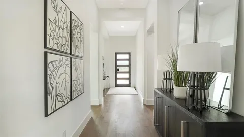 view of a hallway with wooden floor and stairs