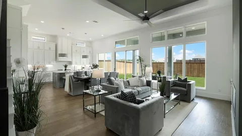 a living room with furniture and large windows