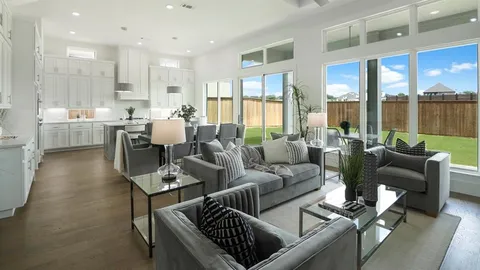 a living room with furniture wooden floor and a large window