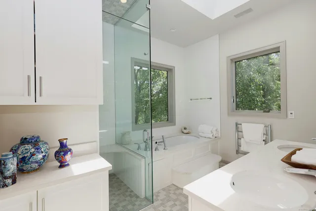 a bathroom with a tub sink and mirror
