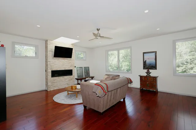 a living room with furniture a fireplace and a flat screen tv