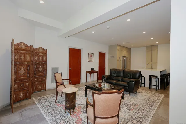 a living room with furniture a rug and a chandelier