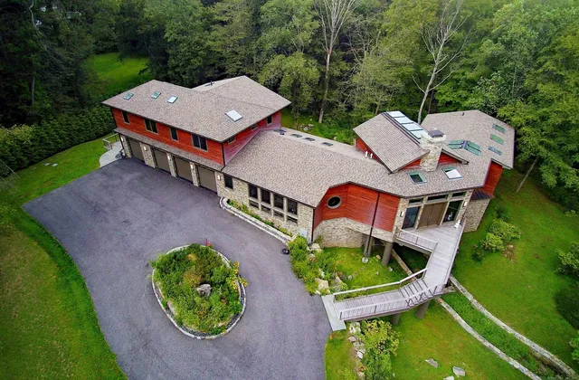 an aerial view of a house with garden space and street view
