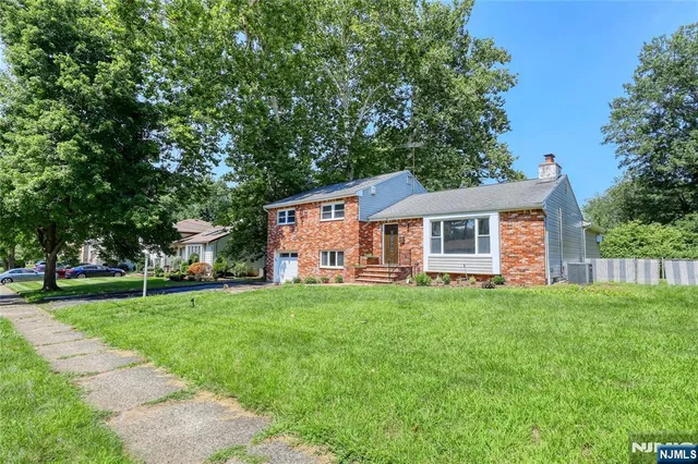 a front view of house with yard and green space