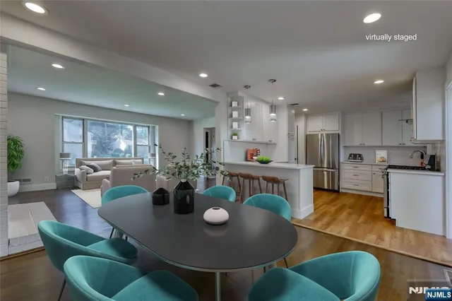 a view of a dining room with furniture and a kitchen