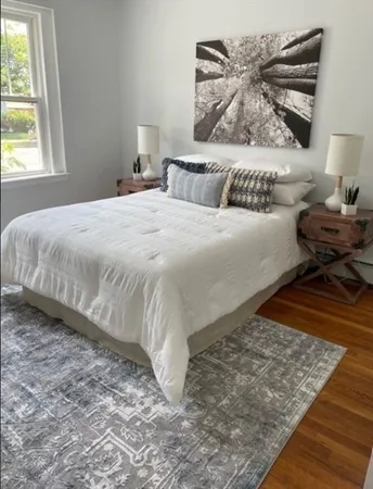 a bedroom with a bed and window