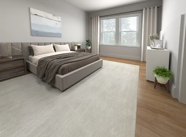 a spacious bedroom with a bed and a large window