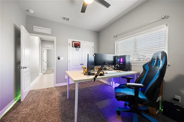 a view of a workspace with furniture and a window