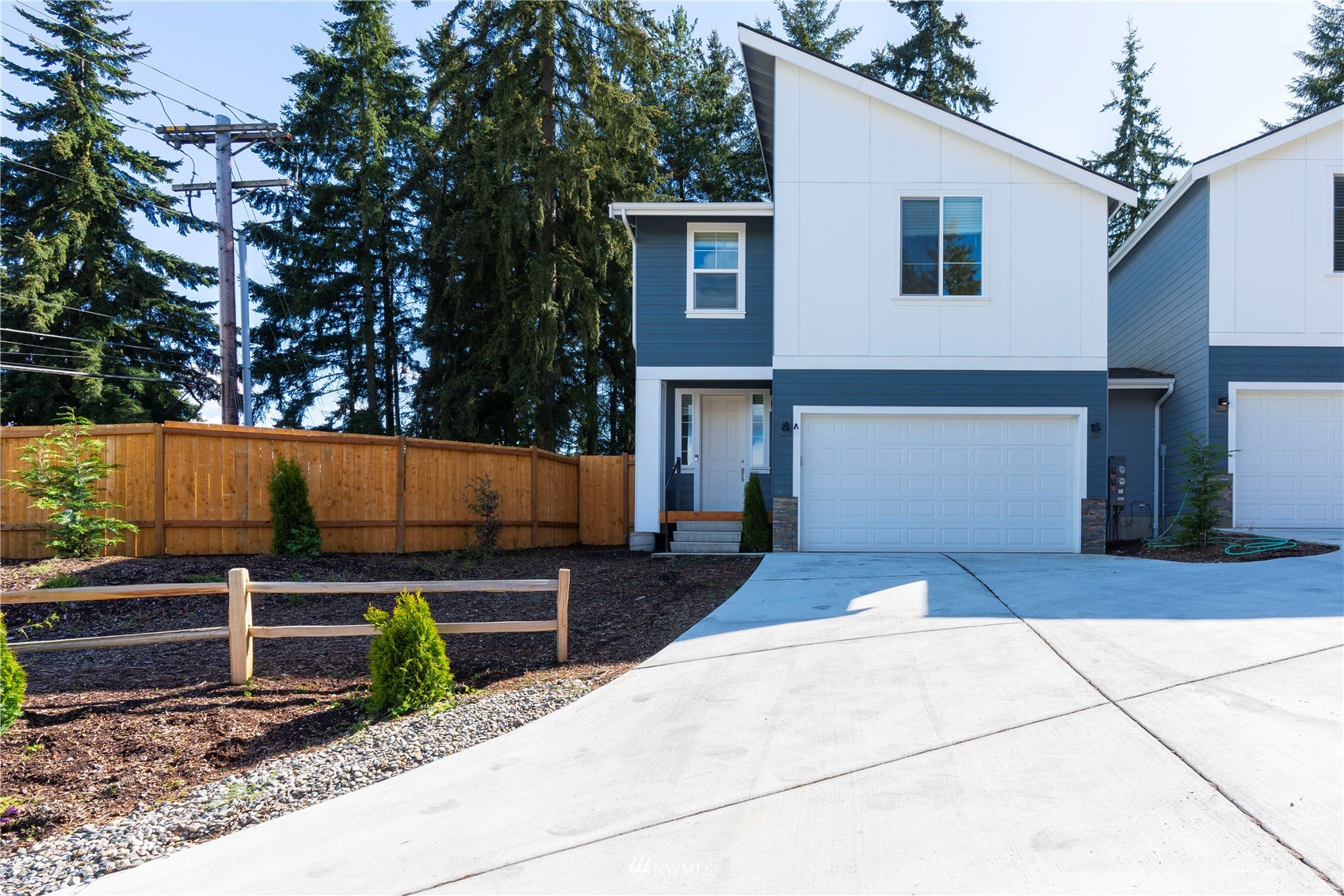 19512 Damson Road, Unit A Lynnwood, WA 98036 - Photo 1 of 37 a view of backyard with wooden fence and a refrigerator