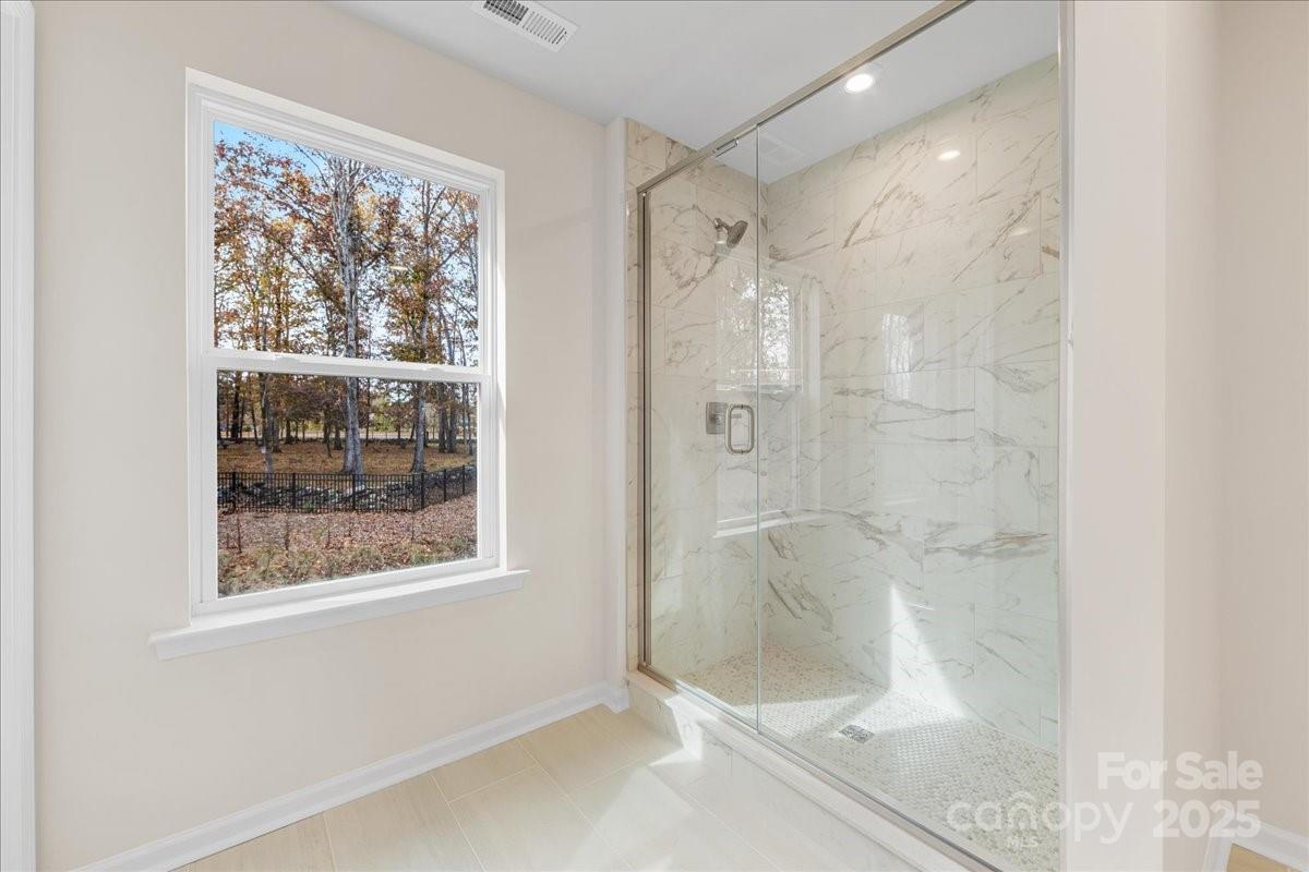 8233 Franklin Trl Street Mint Hill, NC 28227 - Photo 13 of 17 a bathroom with a glass shower door