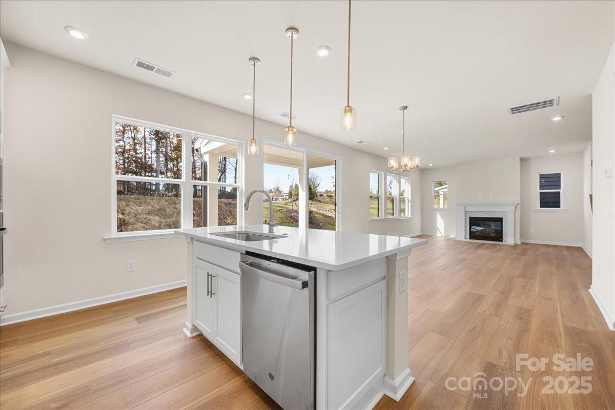 8233 Franklin Trl Street Mint Hill, NC 28227 - Photo 5 of 17 a kitchen with granite countertop a stove a sink a center island and a wooden floor