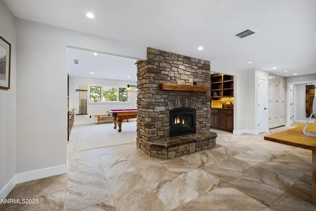 a room with pool table and windows