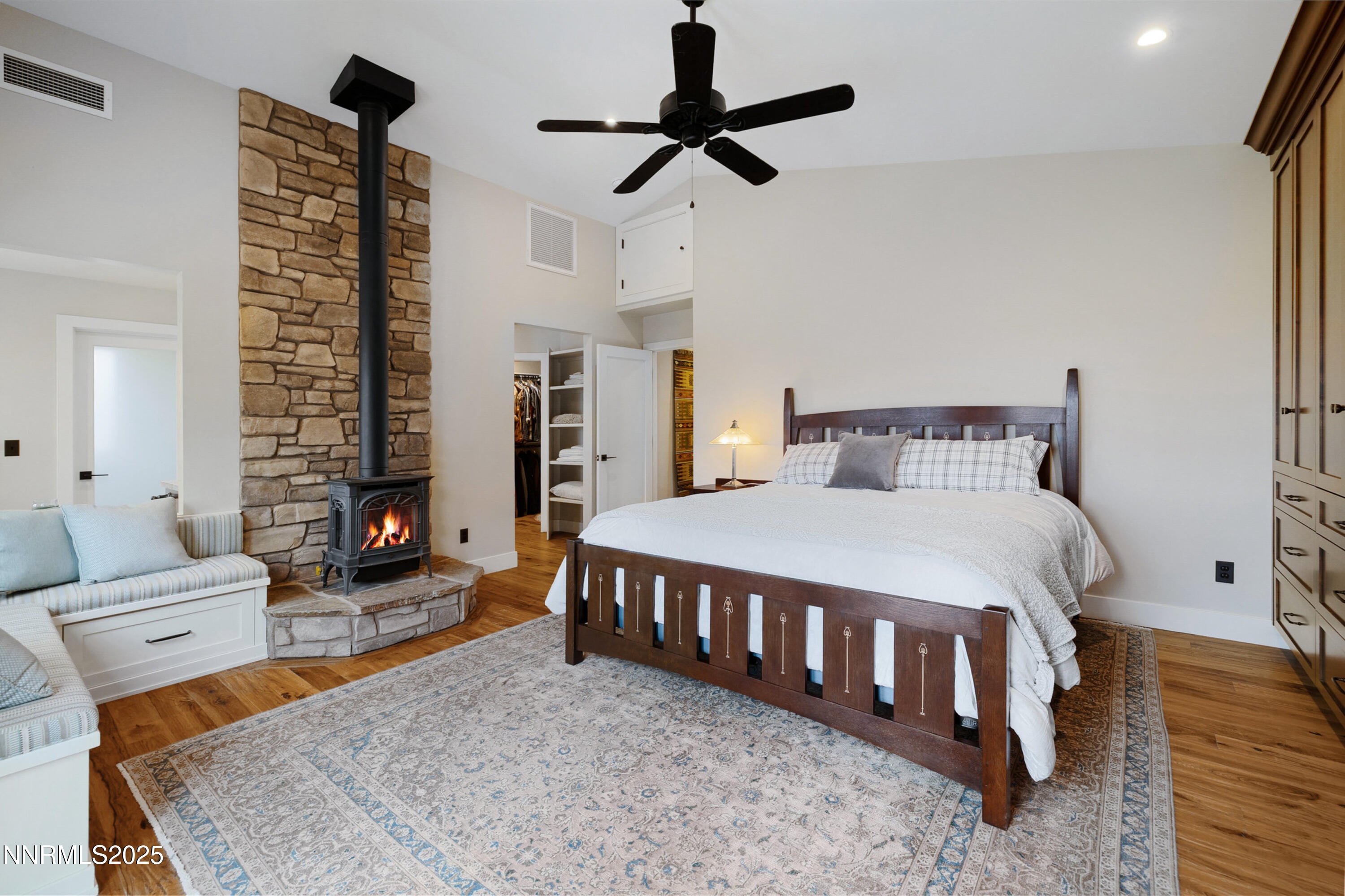 110 Moonstone Lane Reno, NV 89508 - Photo 21 of 68 a spacious bedroom with a bed a couch and a chandelier