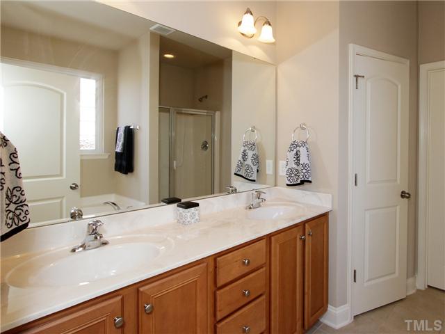 329 Trout Valley Road Wake Forest, NC 27587 - Photo 8 of 15 The master bath has dual vanities, stand up shower and garden tub.