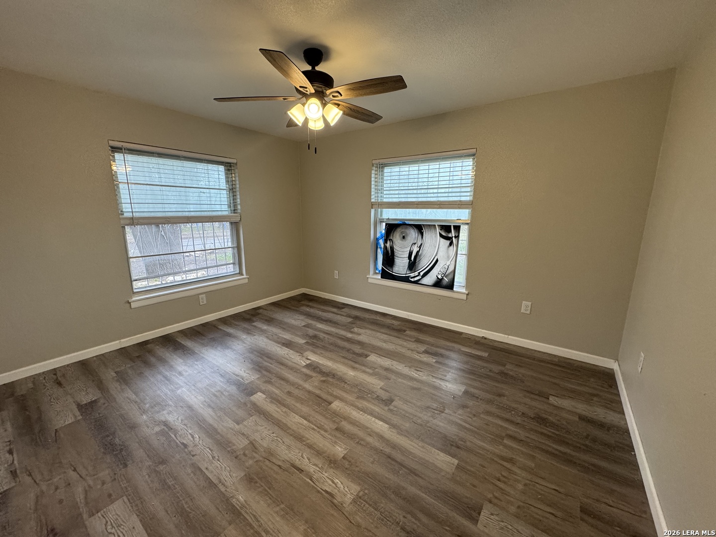 1240 Rice Road San Antonio, TX 78220 - Photo 13 of 45 a view of an empty room with wooden floor and a window