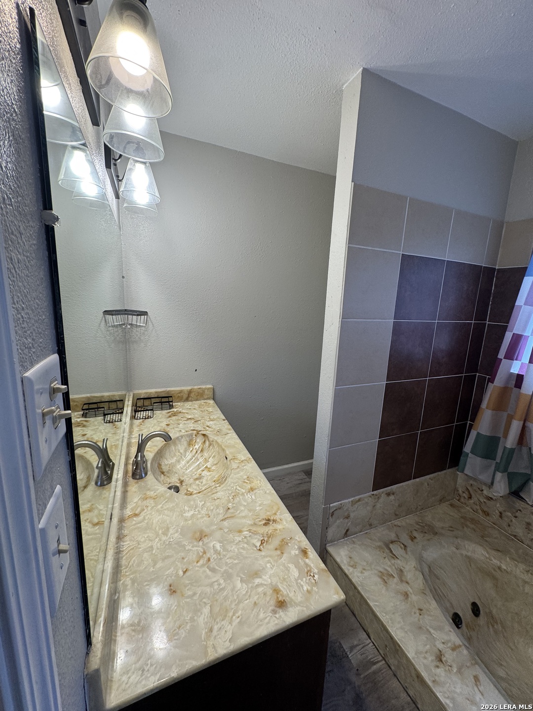 1240 Rice Road San Antonio, TX 78220 - Photo 17 of 45 a bathroom with a sink vanity and shower