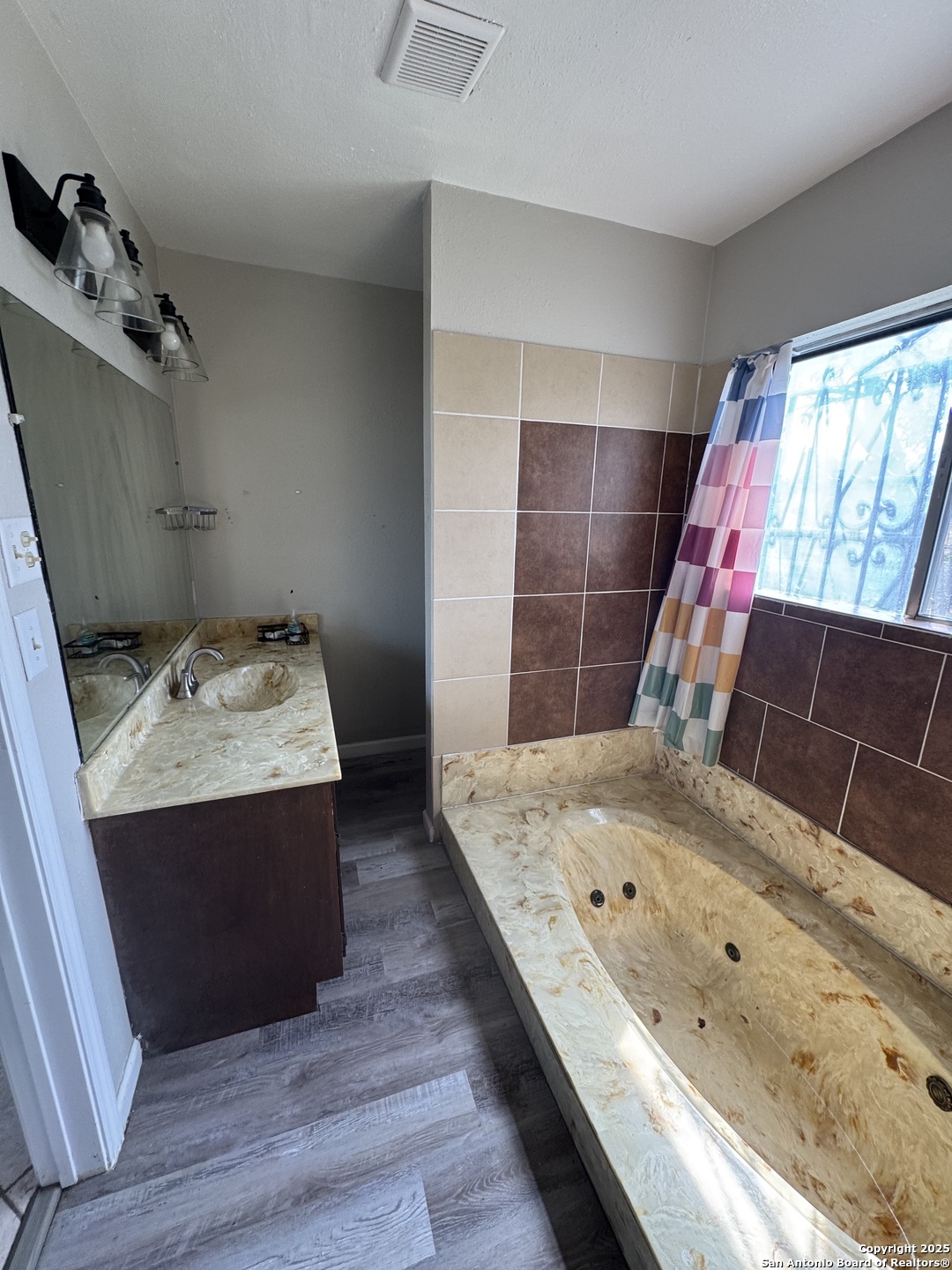 1240 Rice Road San Antonio, TX 78220 - Photo 19 of 45 a bathroom with a tub sink and mirror