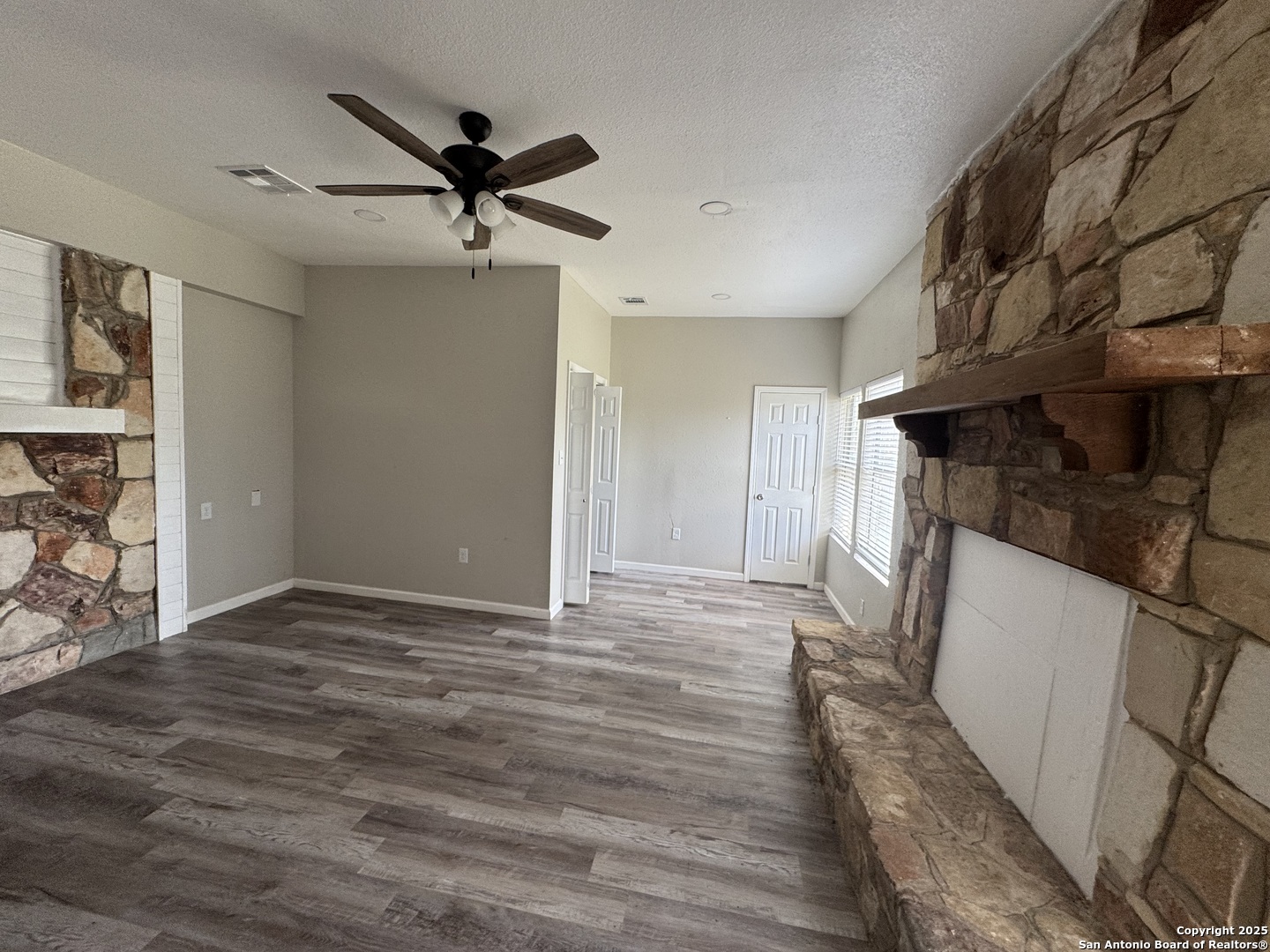 1240 Rice Road San Antonio, TX 78220 - Photo 24 of 45 a view of empty room with wooden floor and fan
