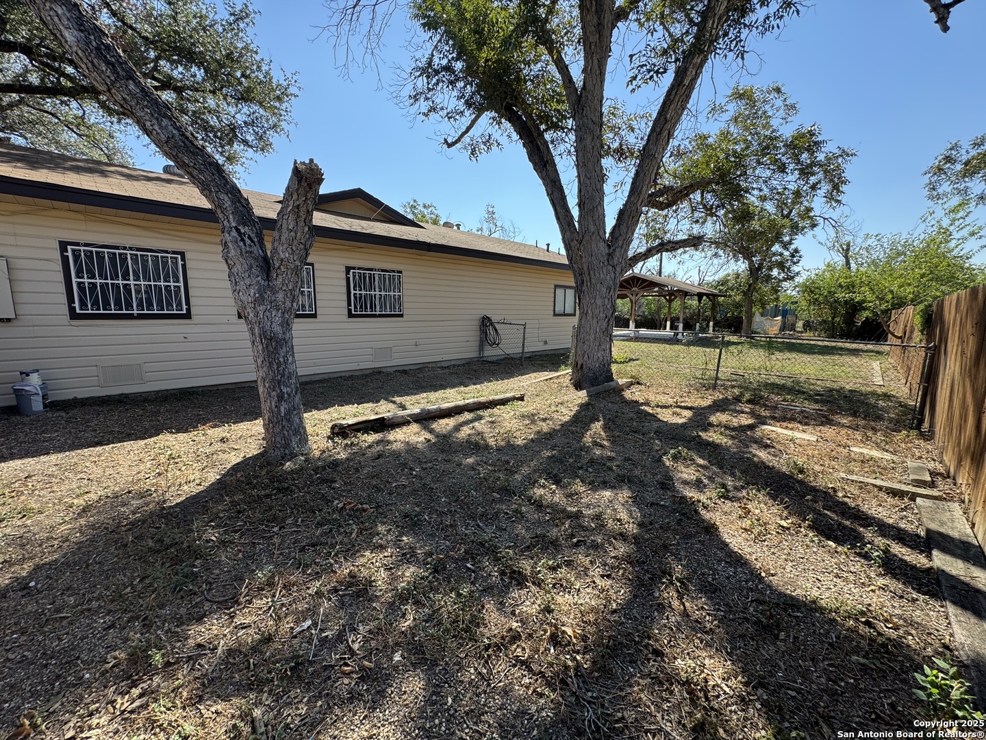 1240 Rice Road San Antonio, TX 78220 - Photo 37 of 45 a view of a house with a tree in the yard